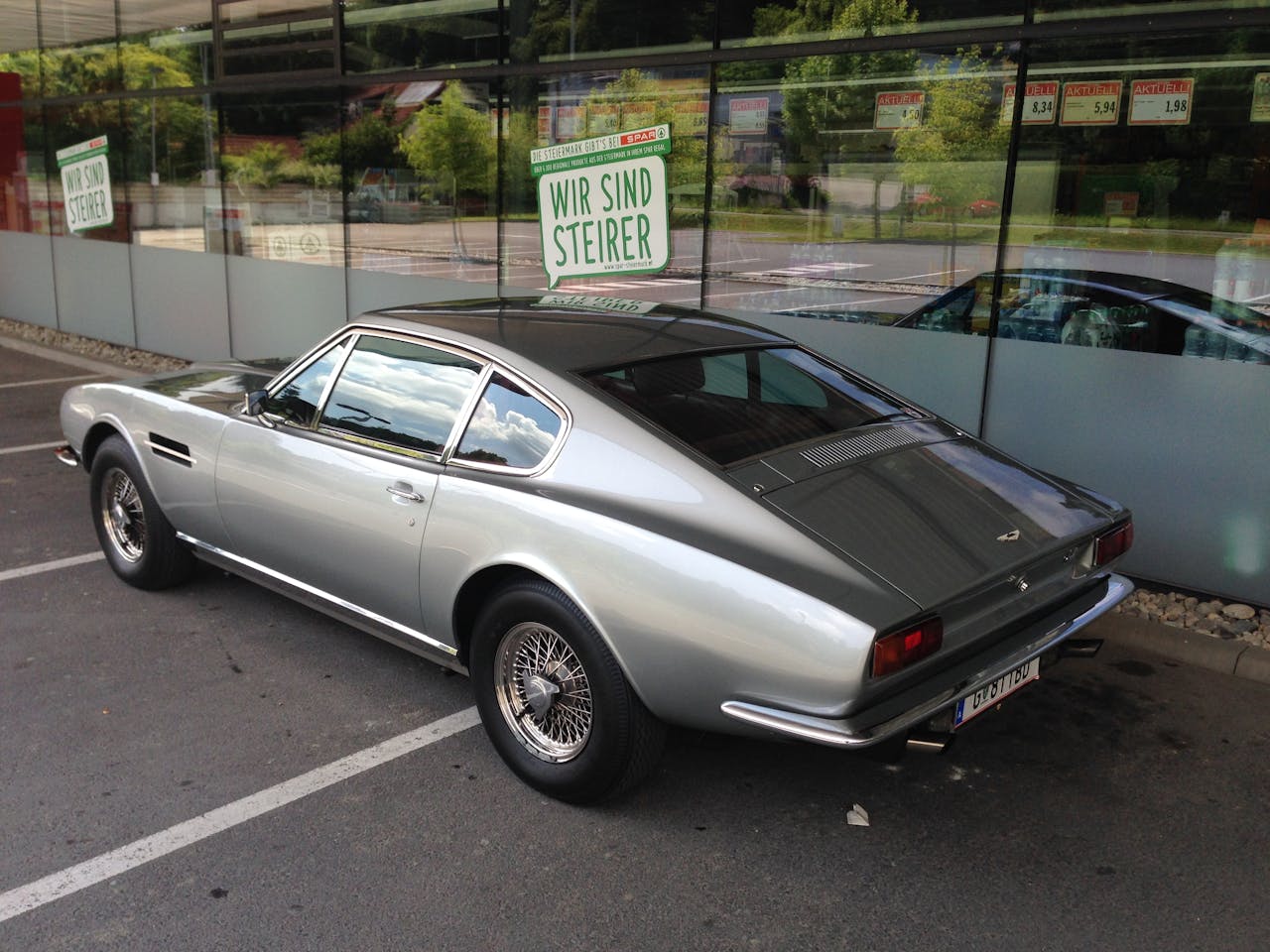 service-02 Classic metallic gray Aston Martin parked outdoors in Graz, Austria.
